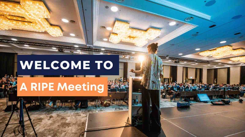Photo of a RIPE meeting with text overlay 'welcome to a RIPE meeting'